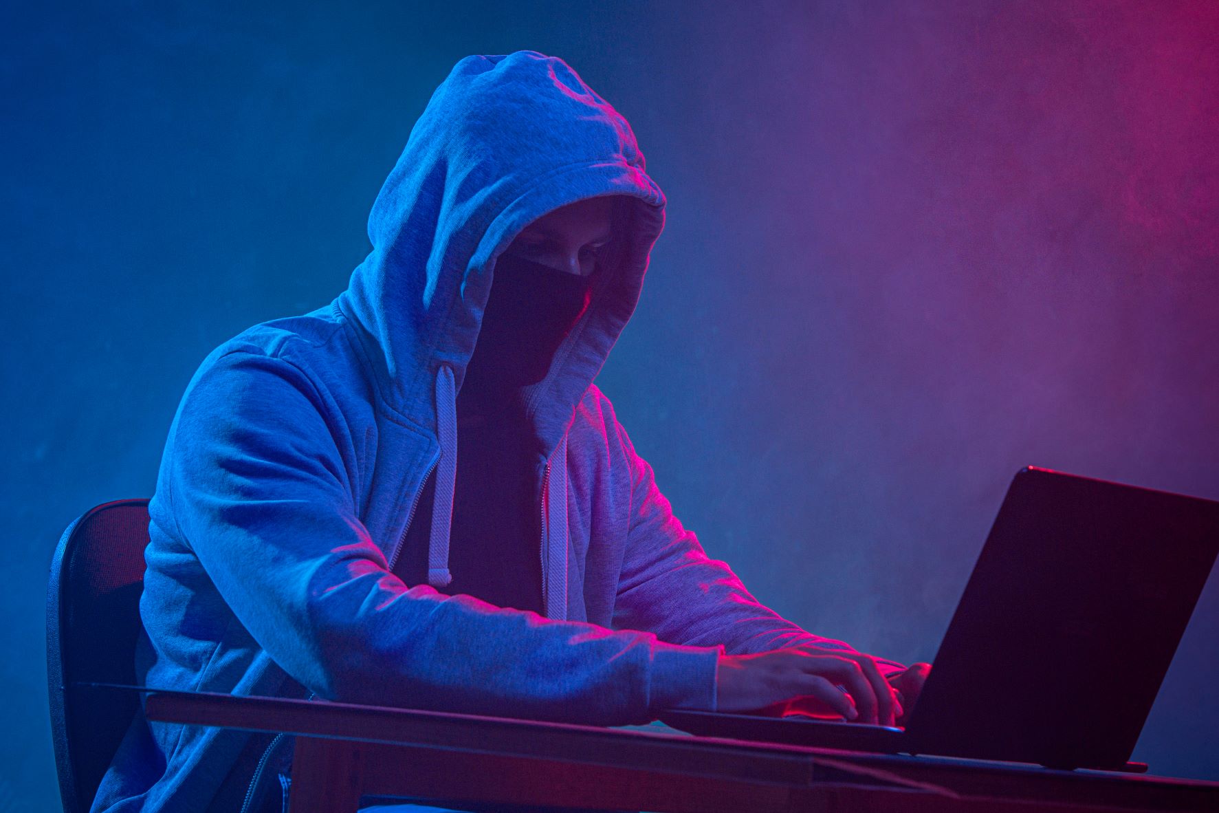 hooded-computer-hacker-stealing-information-with-laptop